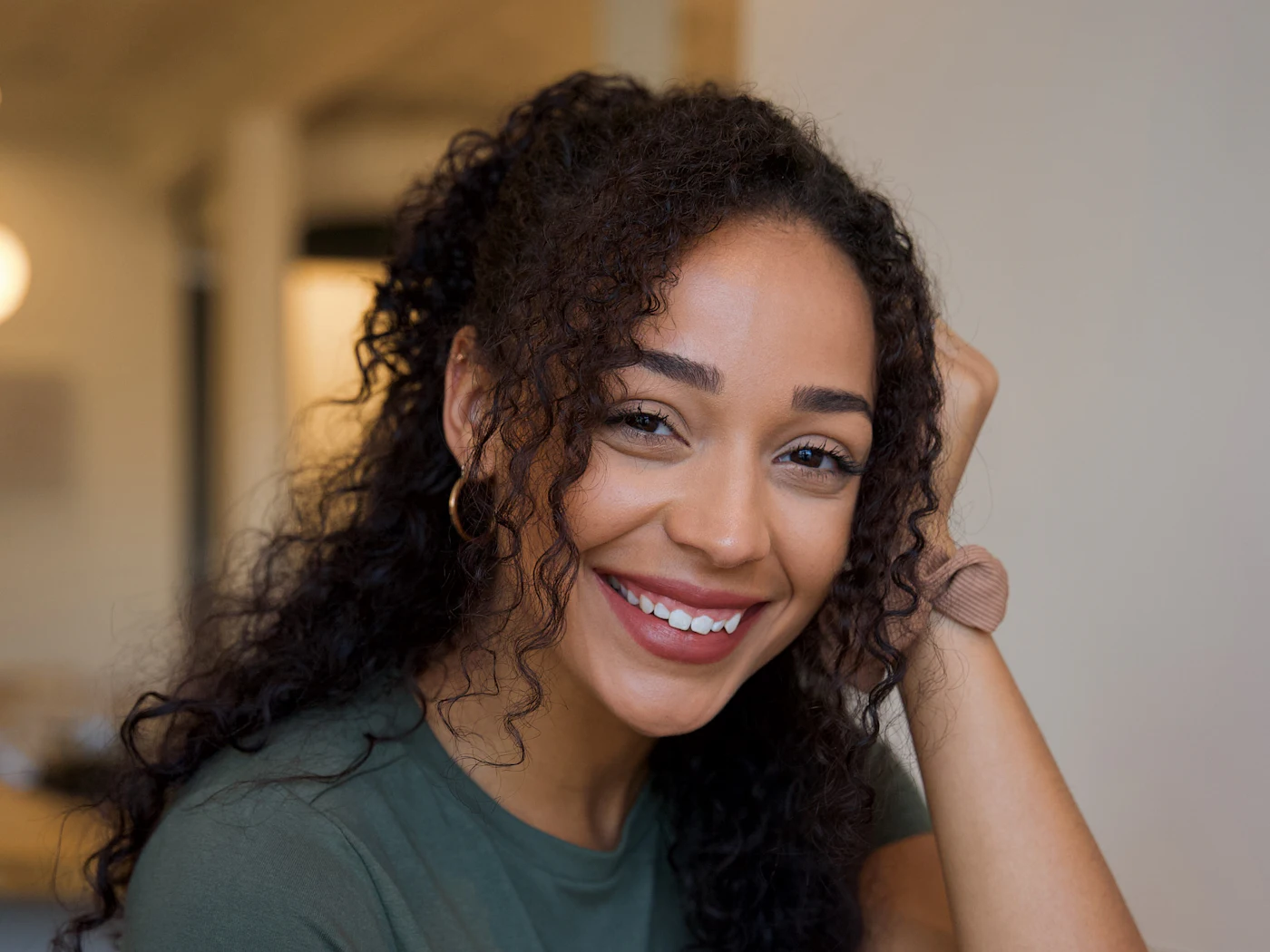A young woman smiling.